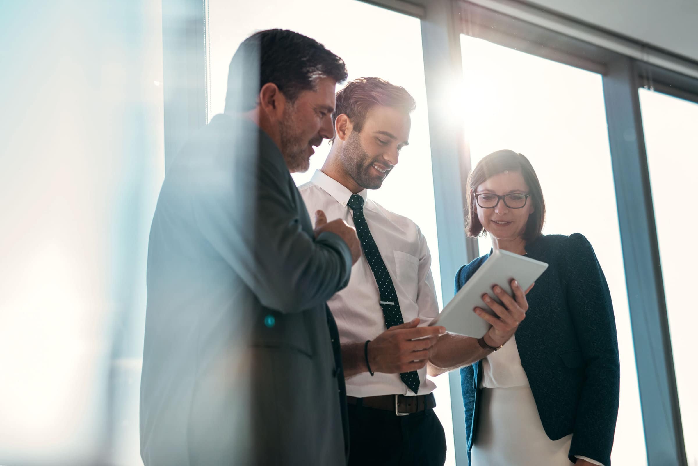 Group,Of,Businesspeople,Using,A,Digital,Tablet,Together,In,Front Group,Of,Businesspeople,Using,A,Digital,Tablet,Together,In,Front