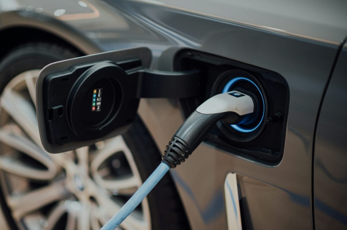 Electric vehicle charging. Photo by CHUTTERSNAP on Unsplash.