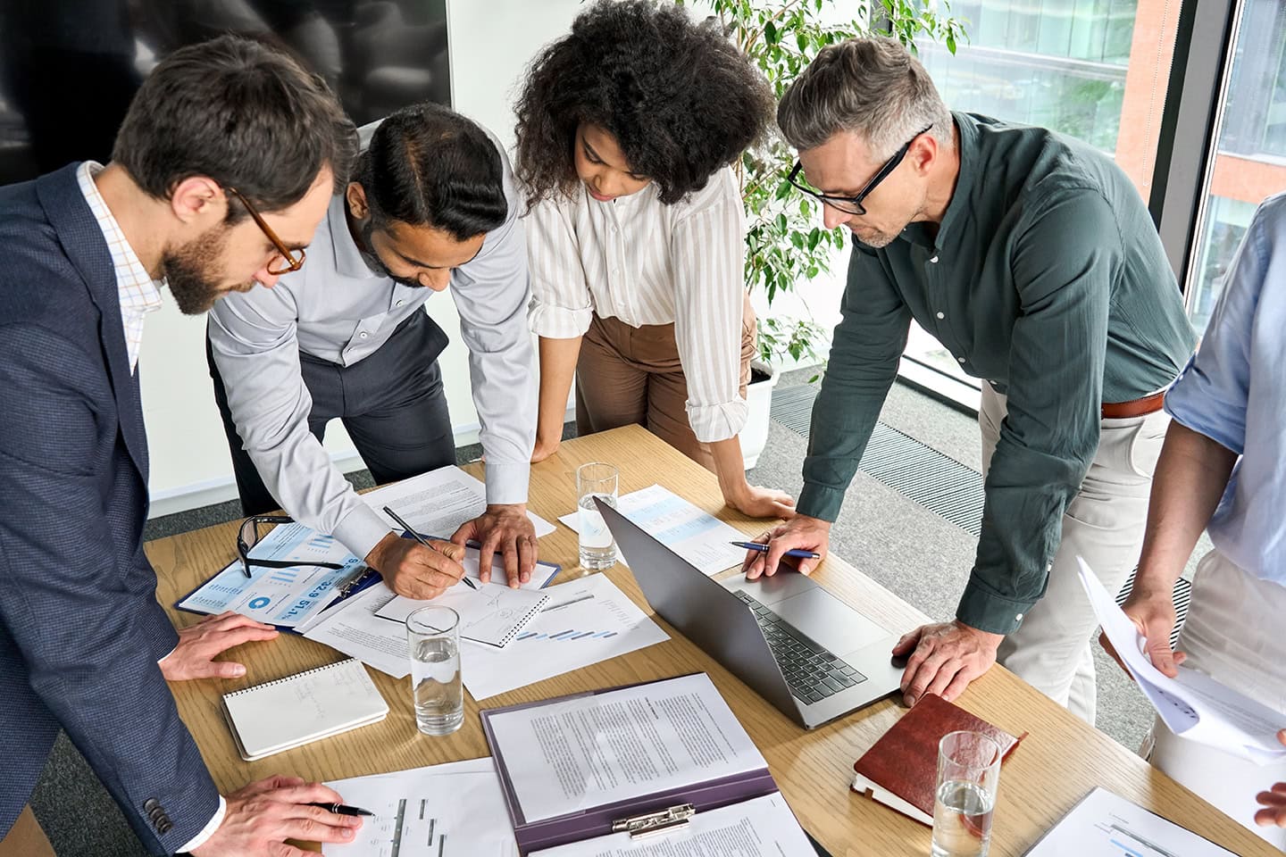 Diverse,International,Executive,Business,People,Group,Brainstorming,At,Boardroom,Meeting Diverse international executive business people group brainstorming at boardroom meeting table. Multiethnic team discussing project developing business strategy doing paperwork analysis in office.
