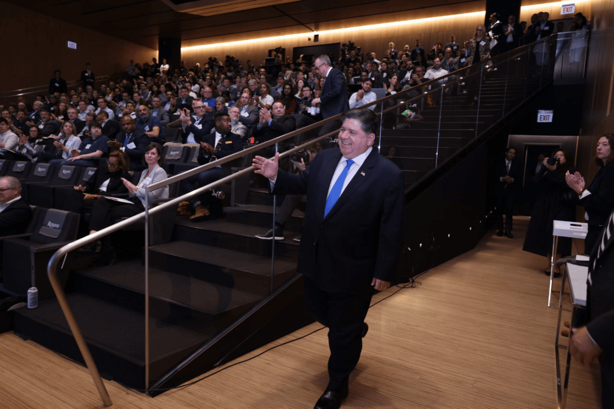 Illinois Governor JB Pritzker greets the crowd at his keynote for the 2024 Chicago Quantum Summit.