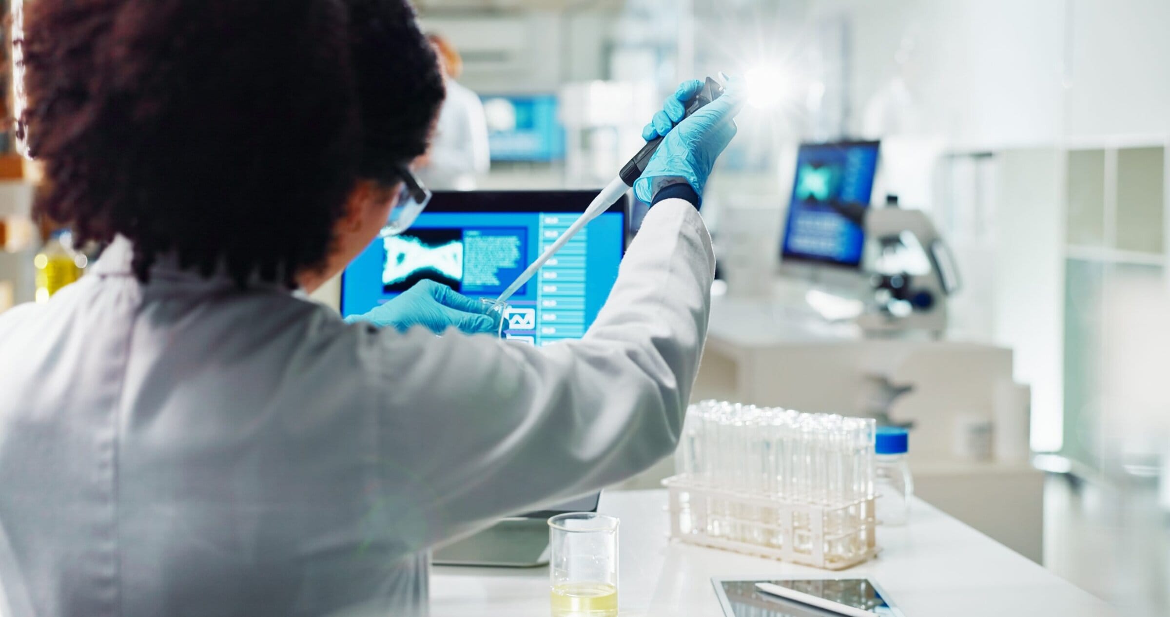 A scientist at work in a lab. Image via Shutterstock.
