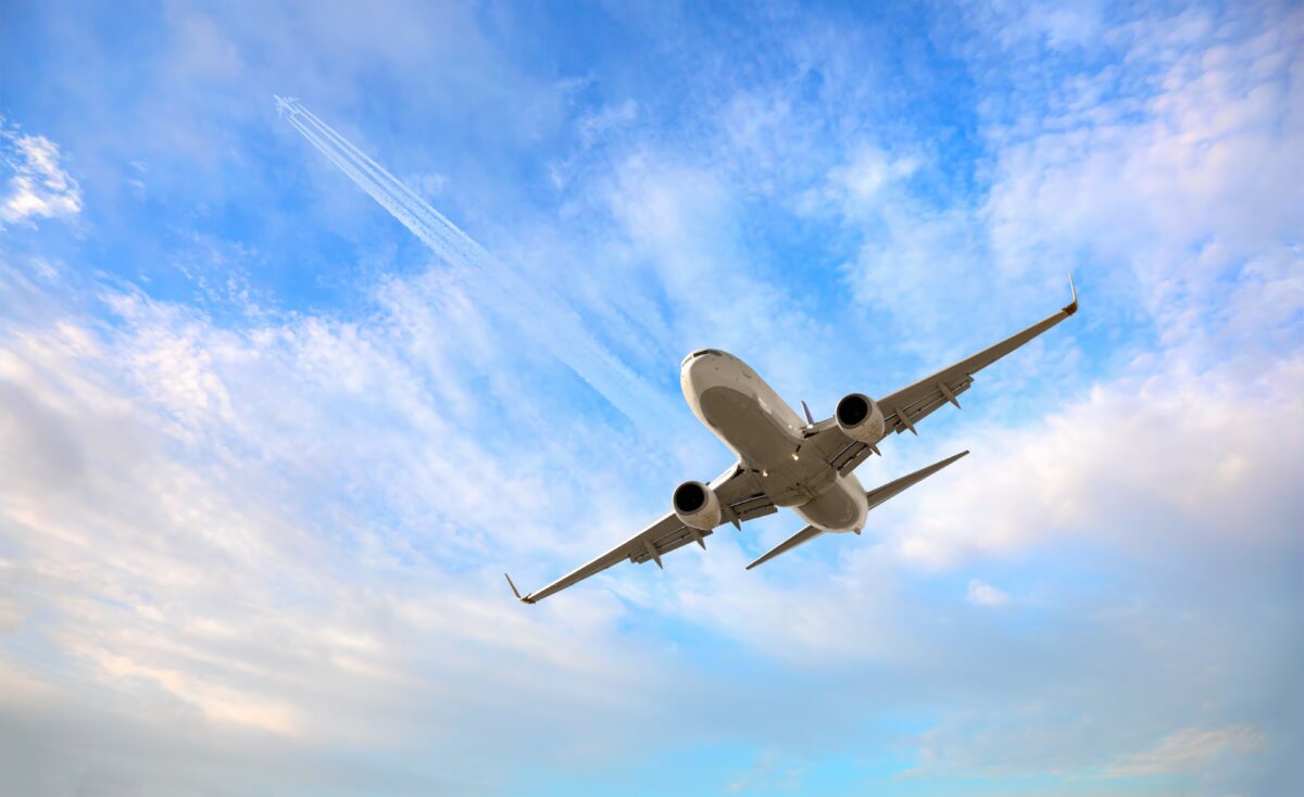 An airplane from below. Image via Shutterstock.